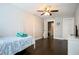 Light-filled bedroom features dark wood floors, a four-poster bed, and a view into the ensuite bathroom at 787 High Grove Park Ct, Oviedo, FL 32765