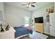 Cozy bedroom featuring a ceiling fan, neutral walls, a window, and light-colored wood furniture at 787 High Grove Park Ct, Oviedo, FL 32765