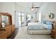 Bright bedroom with wooden furniture, high ceilings, and patio access at 787 High Grove Park Ct, Oviedo, FL 32765