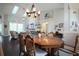 Cozy dining area with a hardwood table, pendant lighting, and a view into the living space at 787 High Grove Park Ct, Oviedo, FL 32765