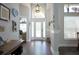 Bright foyer featuring a high ceiling, decorative pendant light, and elegant glass front door at 787 High Grove Park Ct, Oviedo, FL 32765