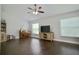 Relaxing living area with a piano, entertainment center, hardwood flooring, and plenty of natural light at 787 High Grove Park Ct, Oviedo, FL 32765