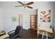Bright home office with a desk, chair, built-in shelving, fresh paint and hardwood floors at 787 High Grove Park Ct, Oviedo, FL 32765