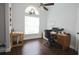 Well-lit home office with a desk, chair, and a large window for natural light and hardwood floors at 787 High Grove Park Ct, Oviedo, FL 32765