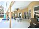 Spacious screened patio with comfortable seating, ceiling fan, and a view of the backyard at 787 High Grove Park Ct, Oviedo, FL 32765