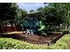 Fun playground with green slide, climbing structure and safety-conscious ground cover at 787 High Grove Park Ct, Oviedo, FL 32765