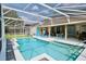 Inviting screened pool with clear blue water, ample seating, and a well-maintained patio at 787 High Grove Park Ct, Oviedo, FL 32765