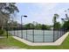 Well-maintained tennis court surrounded by mature trees, ideal for recreational play at 787 High Grove Park Ct, Oviedo, FL 32765