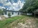 Backyard featuring a house, shed and grassy area at 795 Temple Ave, Orange City, FL 32763
