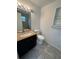Bathroom featuring a modern vanity with granite countertops, a stylish mirror, and tiled flooring at 795 Temple Ave, Orange City, FL 32763