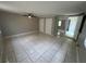 Spacious bedroom offers tile flooring, ample closet space, and neutral walls at 795 Temple Ave, Orange City, FL 32763