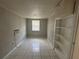 Cozy bedroom offers tile flooring, built-in shelving, and a window for natural light at 795 Temple Ave, Orange City, FL 32763