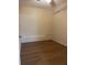 Small unfurnished bedroom has laminate flooring and closet shelving at 795 Temple Ave, Orange City, FL 32763