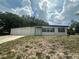 Charming single-story home featuring a large front yard and attached garage at 795 Temple Ave, Orange City, FL 32763