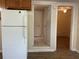 Kitchen featuring white appliances and laminate flooring at 795 Temple Ave, Orange City, FL 32763