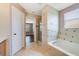 Bathroom featuring soaking tub, tiled shower, and access to bedroom at 806 Sterling Spring Rd, Orlando, FL 32828