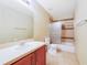 Bathroom features a single vanity, toilet and shower-tub combination with decorative tile surround at 806 Sterling Spring Rd, Orlando, FL 32828