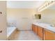 Spacious bathroom featuring double sink vanity, soaking tub, and tiled flooring at 806 Sterling Spring Rd, Orlando, FL 32828