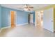 Spacious bedroom features tile flooring, ceiling fan, and large walk-in closet at 806 Sterling Spring Rd, Orlando, FL 32828