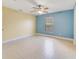 Comfortable bedroom with two-tone walls, tile floors, and a window for natural light at 806 Sterling Spring Rd, Orlando, FL 32828