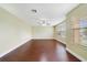 Well-lit room with hardwood floors, ceiling fan, and large window at 806 Sterling Spring Rd, Orlando, FL 32828