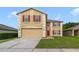 Two-story home with a neutral color scheme, red shutters, and a well-maintained front lawn at 806 Sterling Spring Rd, Orlando, FL 32828