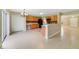 Spacious kitchen with oak cabinetry, tile flooring, and modern appliances, seamlessly connects to the dining area at 806 Sterling Spring Rd, Orlando, FL 32828