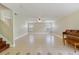 Expansive living area with neutral walls, tiled flooring, a ceiling fan, and a staircase nearby at 806 Sterling Spring Rd, Orlando, FL 32828