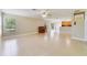 Open concept living area featuring tile floors, large windows, and a view into the kitchen and backyard at 806 Sterling Spring Rd, Orlando, FL 32828