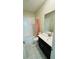The bathroom featuring a vanity with a countertop, white tiled walls and marble floors at 851 Drop Shot Dr, Davenport, FL 33896