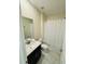 Clean bathroom featuring a vanity with a countertop, a mirror and marble floors at 851 Drop Shot Dr, Davenport, FL 33896