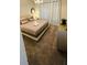 Comfortable bedroom features neutral decor, a queen-size bed, and a luxurious light fixture at 851 Drop Shot Dr, Davenport, FL 33896