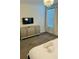 This serene bedroom features a TV, dresser, neutral colors, and plenty of natural light at 851 Drop Shot Dr, Davenport, FL 33896