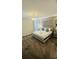 This gorgeous main bedroom features a queen-size bed, natural lighting and neutral decor at 851 Drop Shot Dr, Davenport, FL 33896
