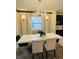 Elegant dining room featuring a large table with modern chairs and a chandelier at 851 Drop Shot Dr, Davenport, FL 33896