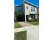 Modern two-story home featuring a stone-accented garage and manicured landscaping at 851 Drop Shot Dr, Davenport, FL 33896