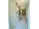 Inviting hallway with decorative wallpaper and marble-look tiled floors at 851 Drop Shot Dr, Davenport, FL 33896
