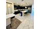 Modern kitchen with dark cabinets, a white countertop island, and stainless steel appliances at 851 Drop Shot Dr, Davenport, FL 33896