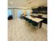 Open-concept kitchen with a large island, bar stools, and adjacent dining area at 851 Drop Shot Dr, Davenport, FL 33896