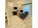 Elegant living room with a chandelier, stylish furniture, and marble-look tile at 851 Drop Shot Dr, Davenport, FL 33896