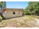 Expansive backyard with a sturdy block home and partial fencing, offering ample space for outdoor activities at 1111 Liberty Ave, Mount Dora, FL 32757
