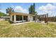 Spacious backyard with patio, pergola, and lush lawn, perfect for outdoor activities and relaxation at 1111 Liberty Ave, Mount Dora, FL 32757