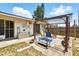 Inviting backyard patio with pergola, outdoor seating, and garden decor, perfect for relaxing or entertaining at 1111 Liberty Ave, Mount Dora, FL 32757