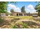 Expansive backyard with a screen porch, patio with pergola, and vehicle, offering ample space at 1111 Liberty Ave, Mount Dora, FL 32757