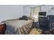 Well-lit bedroom with carpet features a cozy bed, desk, and computer setup, perfect for work or relaxation at 1111 Liberty Ave, Mount Dora, FL 32757