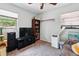 Well-lit bedroom featuring dark shelving, tv, and unique decor, creating a cozy atmosphere at 1111 Liberty Ave, Mount Dora, FL 32757