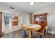 Cozy dining area features a round table, wood floors, and charming built-in china cabinet at 1111 Liberty Ave, Mount Dora, FL 32757