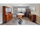 Bright dining area with wood floors, vintage china cabinet, and sunlit window at 1111 Liberty Ave, Mount Dora, FL 32757