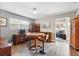 Open-concept dining room with modern furniture and a sleek wood floor at 1111 Liberty Ave, Mount Dora, FL 32757