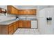 This well-lit kitchen features wooden cabinetry, tile floors, and a white refrigerator at 1111 Liberty Ave, Mount Dora, FL 32757